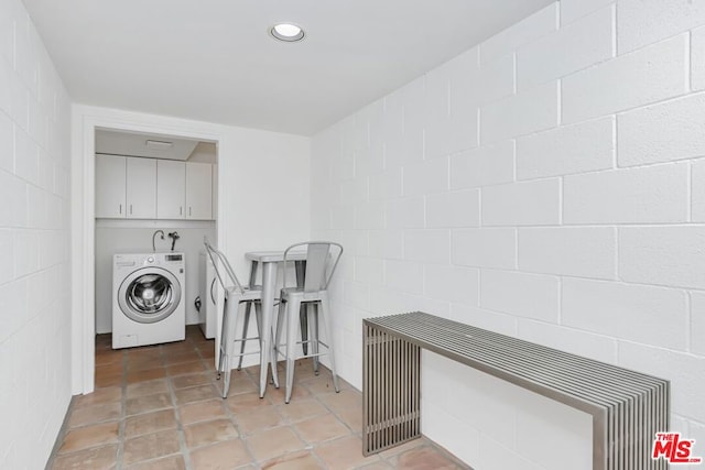 washroom featuring cabinets, washer / dryer, and light tile patterned floors