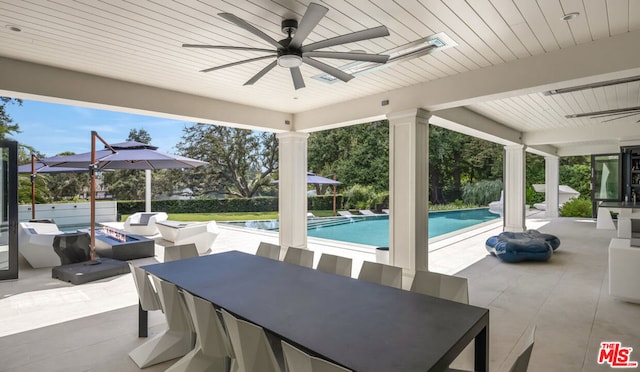 view of patio / terrace featuring ceiling fan and a fire pit