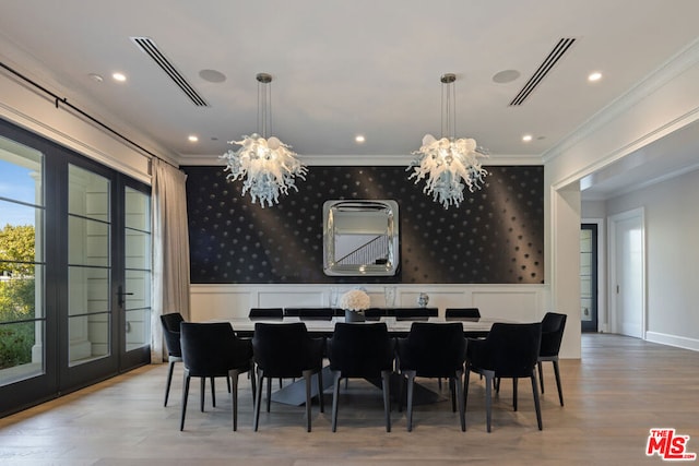 dining area featuring ornamental molding and a notable chandelier