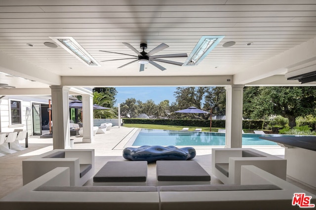 view of swimming pool featuring a patio, an outdoor hangout area, and ceiling fan