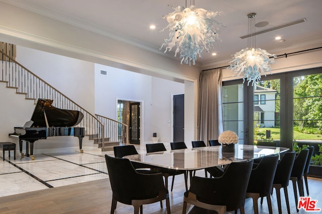 dining area featuring an inviting chandelier, crown molding, french doors, and hardwood / wood-style flooring