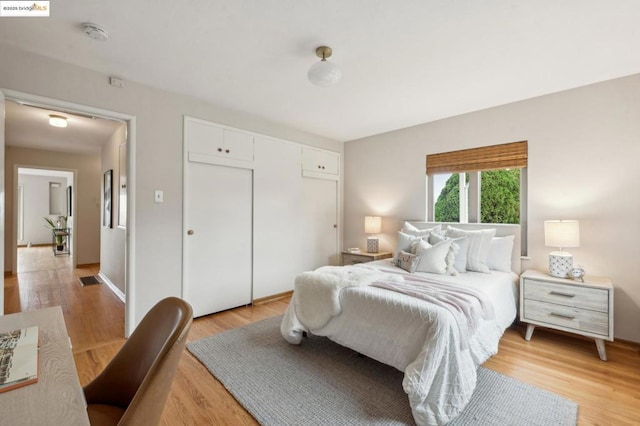 bedroom featuring a closet and light wood-type flooring