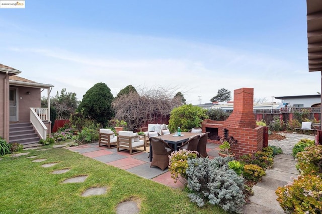 view of patio featuring an outdoor living space with a fireplace