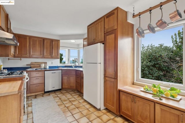 kitchen featuring butcher block counters, sink, range with gas cooktop, dishwasher, and white fridge