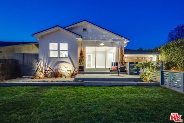 rear view of house with a yard