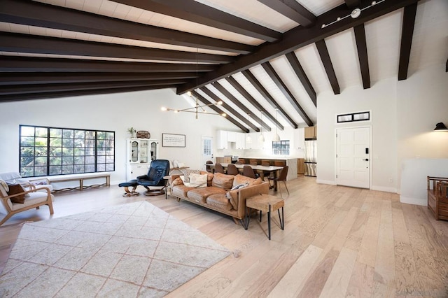 living room featuring beam ceiling, light hardwood / wood-style floors, and high vaulted ceiling