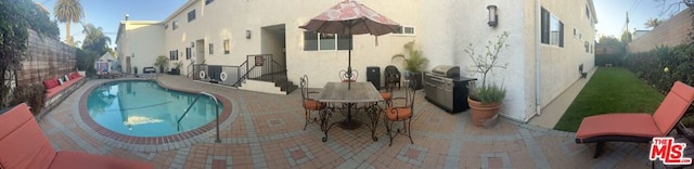 view of pool with a grill and a patio area