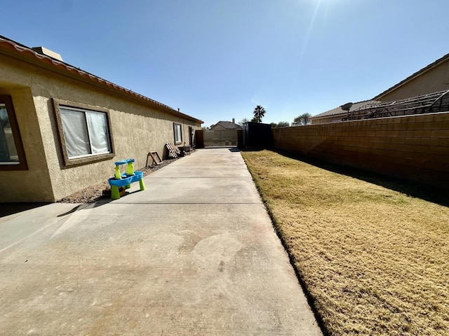 view of side of home featuring a patio area