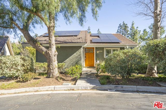 view of front facade with solar panels