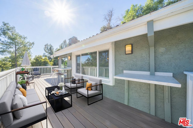 wooden deck with an outdoor living space