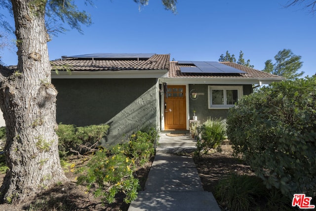 view of front of home with solar panels