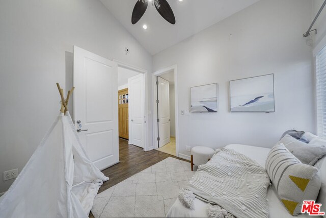 bedroom featuring vaulted ceiling, hardwood / wood-style floors, and ceiling fan