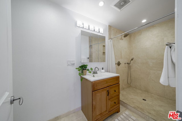 bathroom with vanity, tile patterned floors, and walk in shower