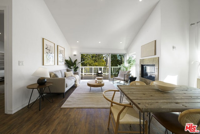 living room featuring dark hardwood / wood-style flooring, high vaulted ceiling, and a multi sided fireplace