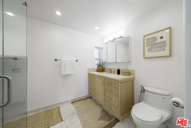 bathroom with an enclosed shower, vanity, and toilet