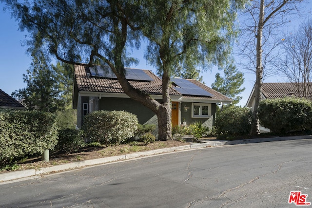 view of front of property with solar panels