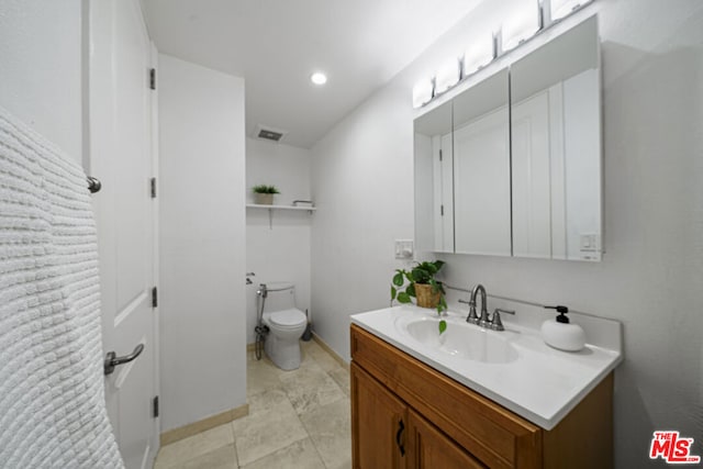 bathroom with vanity and toilet