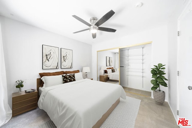 carpeted bedroom with a closet and ceiling fan