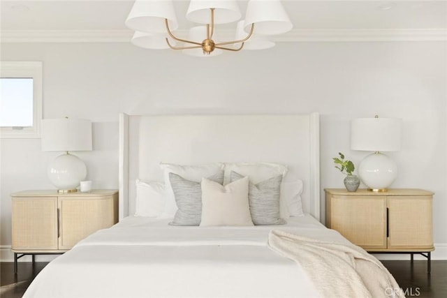 bedroom with dark hardwood / wood-style flooring, crown molding, and a chandelier