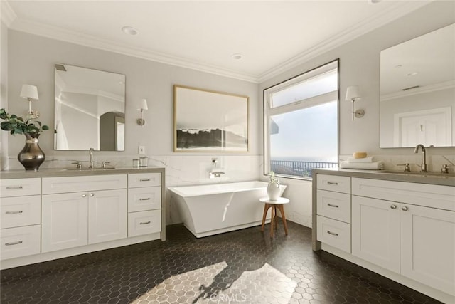 bathroom with crown molding, a tub, tile walls, and vanity