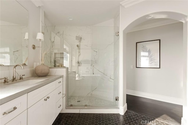 bathroom with vanity, crown molding, and walk in shower