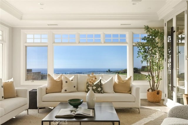 sunroom featuring a water view