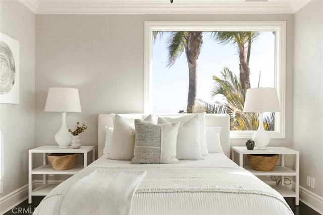 bedroom with ornamental molding and hardwood / wood-style floors