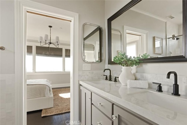 bathroom with crown molding, vanity, and hardwood / wood-style floors