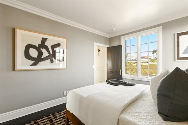 bedroom with ornamental molding and hardwood / wood-style floors