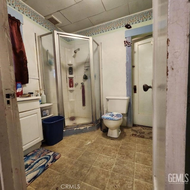 bathroom with walk in shower, vanity, and toilet