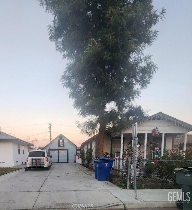 view of front of home with a porch, a garage, and an outdoor structure