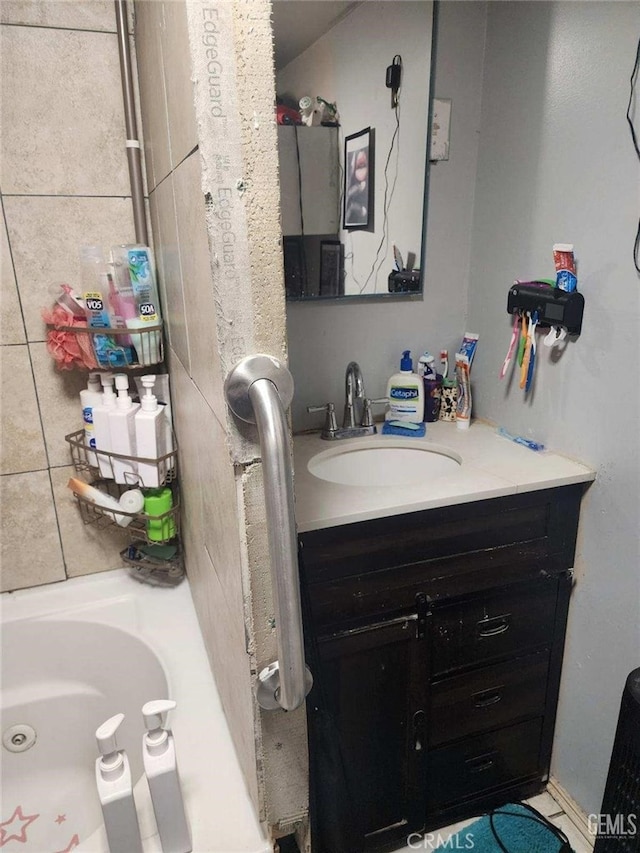 bathroom with vanity and a bath