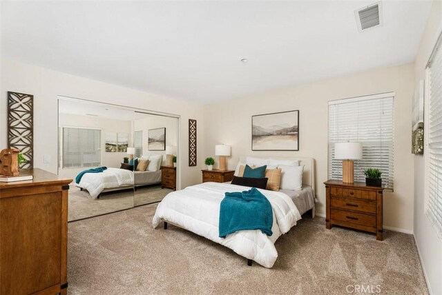 carpeted bedroom with a closet