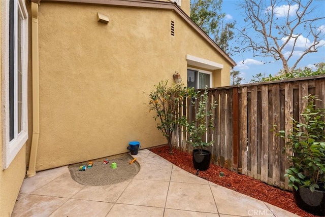 view of property exterior with a patio area