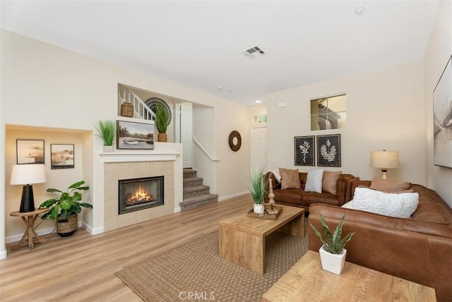 living room with a fireplace and light hardwood / wood-style flooring