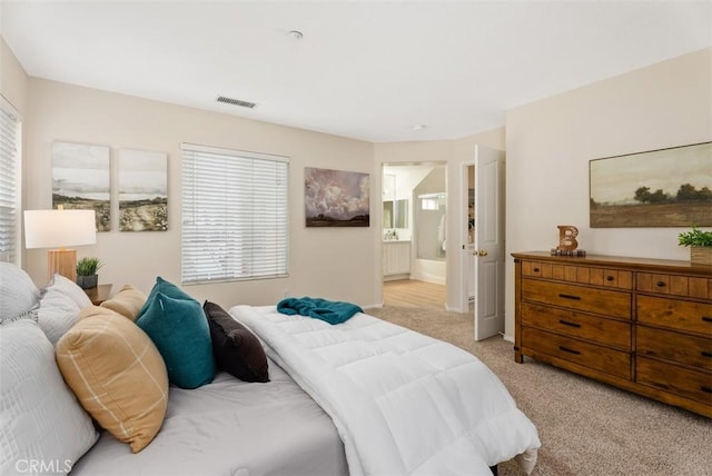 carpeted bedroom with ensuite bathroom