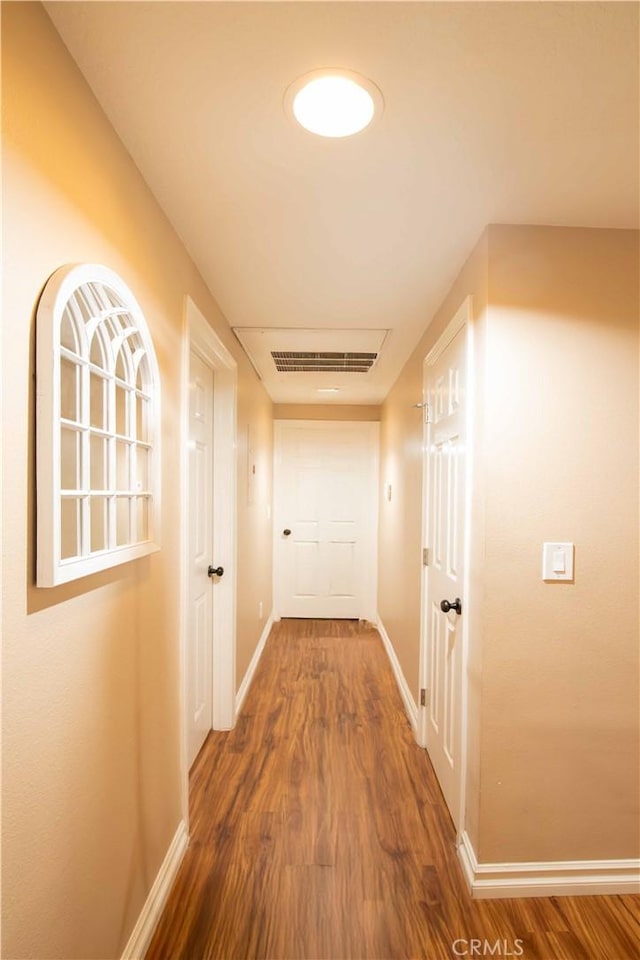 hallway with hardwood / wood-style floors