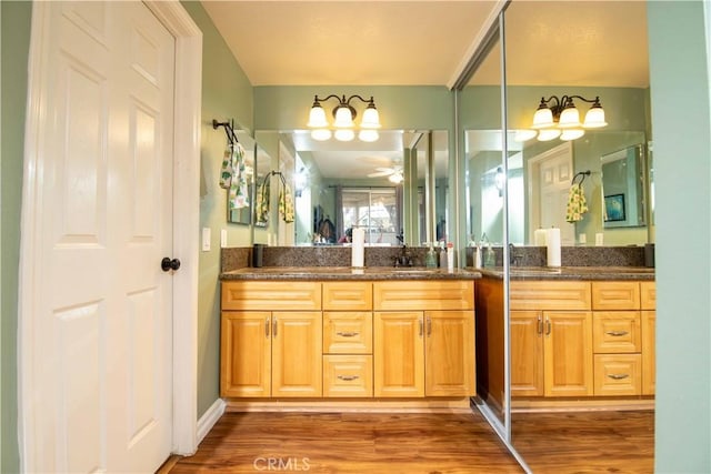 bathroom with vanity, hardwood / wood-style flooring, and ceiling fan