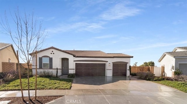 mediterranean / spanish-style home with a garage