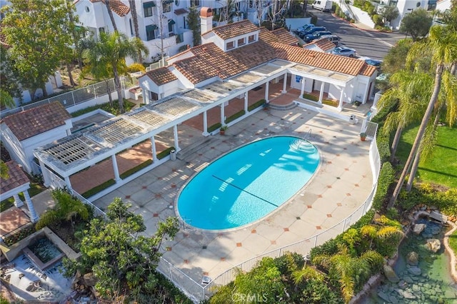 pool featuring fence and a patio