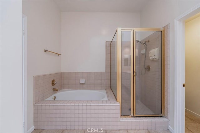 full bathroom with a stall shower, tile patterned floors, and a bath