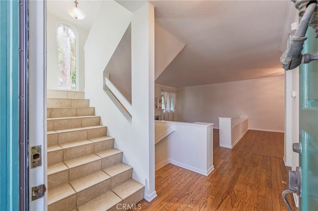 entryway featuring stairway, wood finished floors, and baseboards