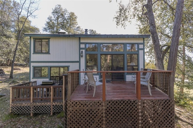 back of house featuring a deck