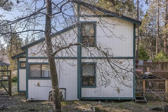 view of home's exterior with a wooden deck