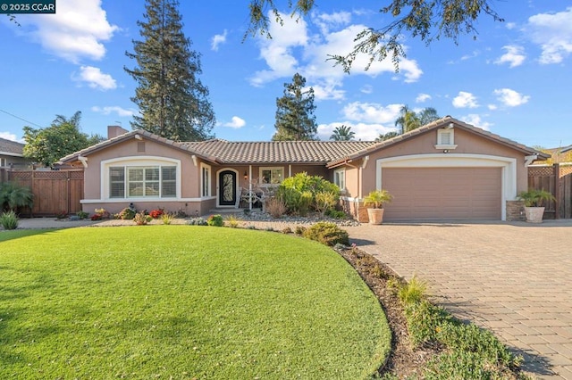 ranch-style house with a garage and a front yard