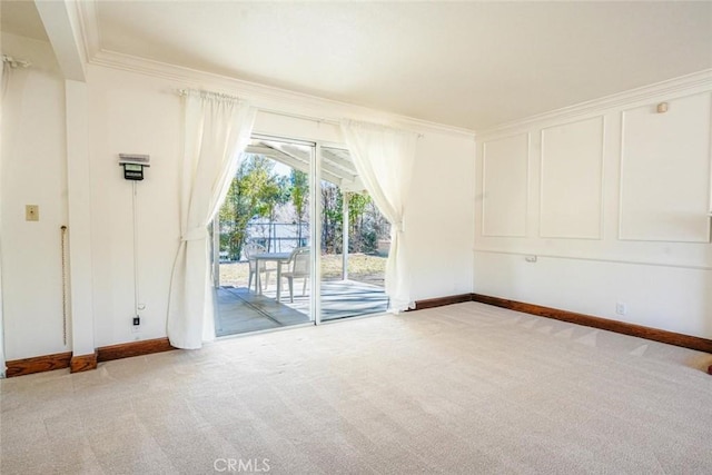 carpeted spare room with crown molding