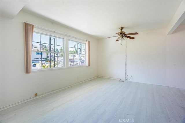 empty room with ceiling fan and light wood-type flooring