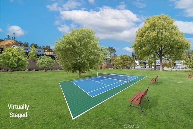 view of sport court with a lawn