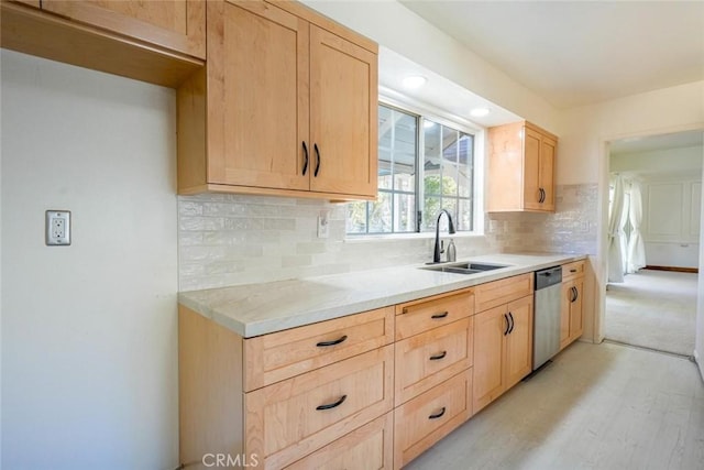 kitchen featuring light brown cabinetry, sink, tasteful backsplash, light hardwood / wood-style flooring, and dishwasher