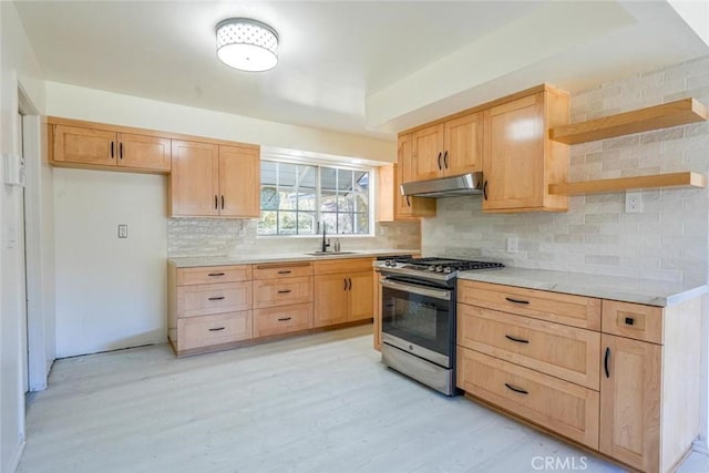 kitchen with light brown cabinetry, sink, and stainless steel range with gas stovetop